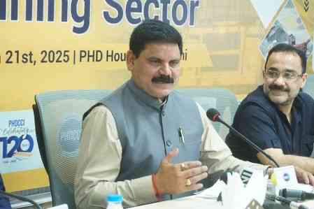 Satish Chandra Dubey speaking at a PHDCCI panel table, with a banner behind reading Mining Sector, 21st 2025, PHD House